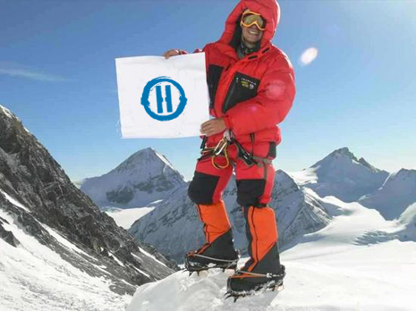 Heroik man on mountain with Heroik flag