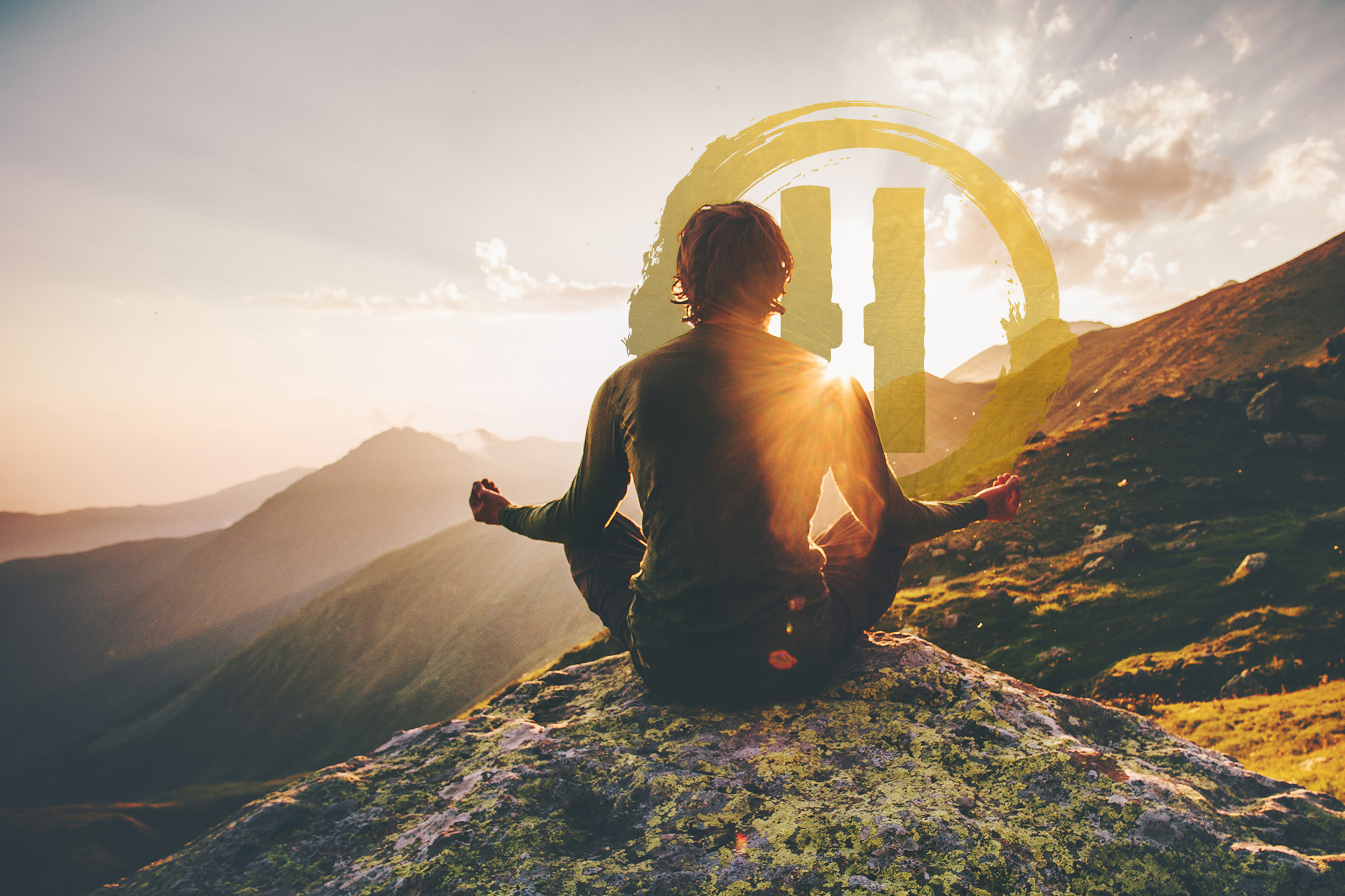 man meditating on mountain in front of Golden Heroik Logo
