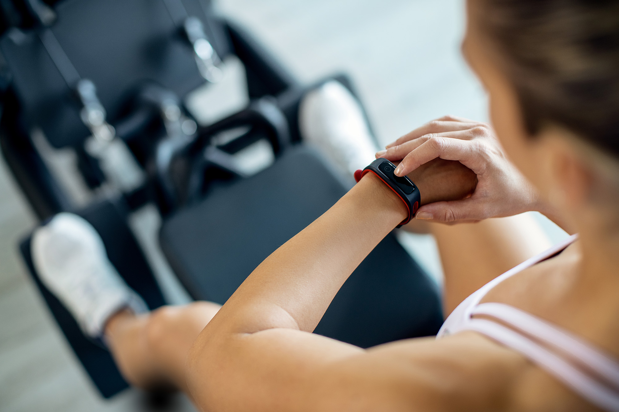 woman looking at smart watch while working out