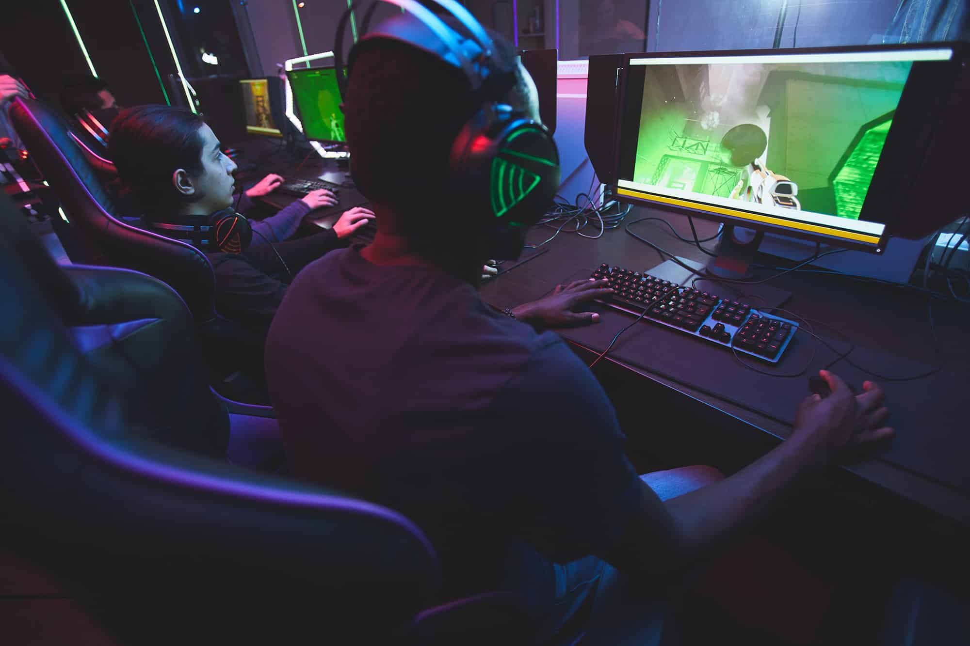 kids playing video games together on computers