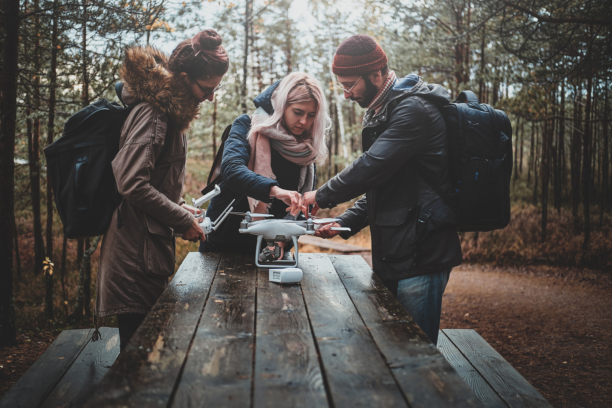 group outdoors assembling a drone